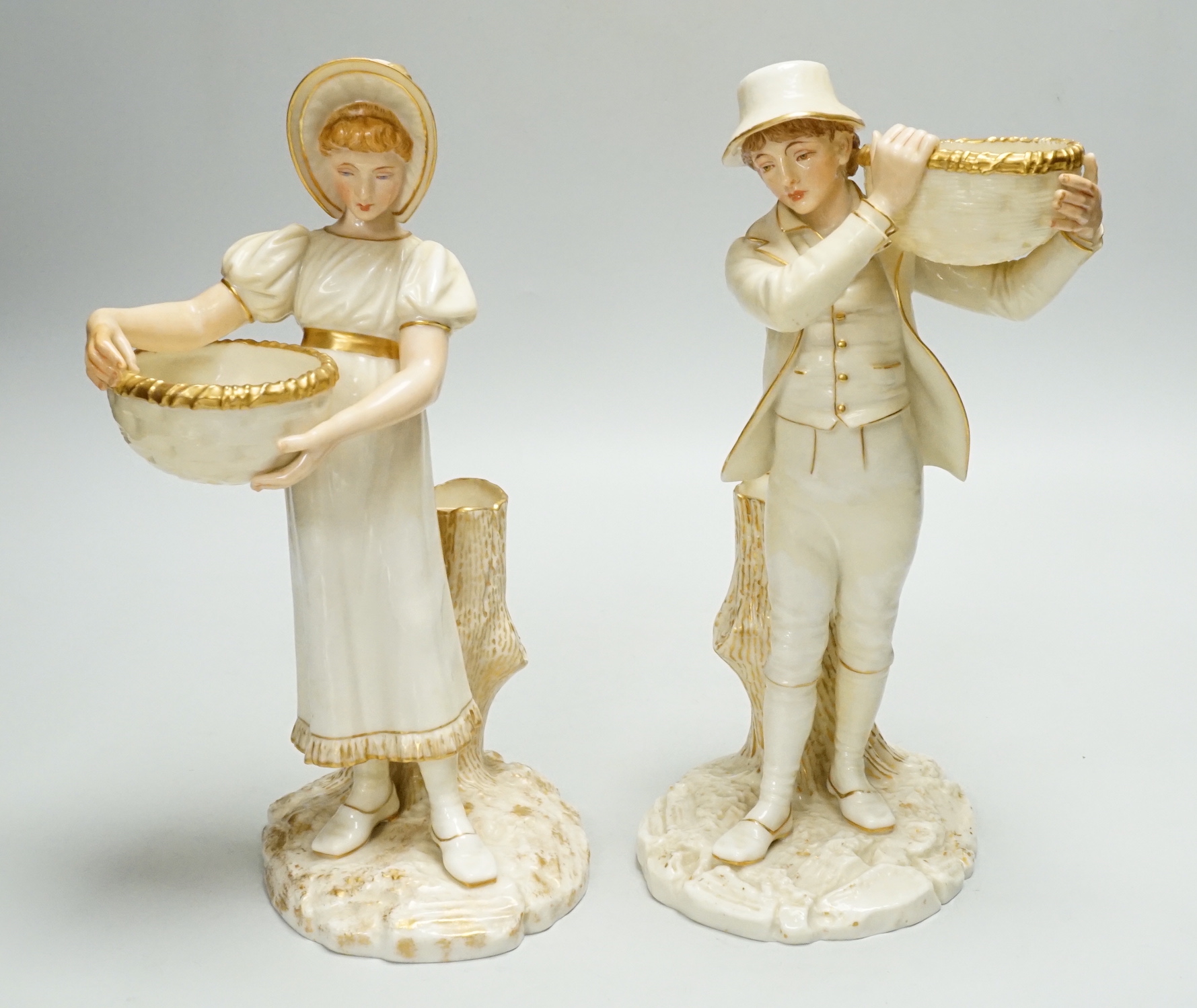 A pair of Worcester porcelain figures, modelled as a boy and girl with baskets, shape number 880, 26cm
